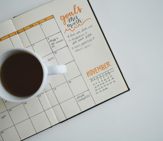 적정 체중을 유지하는 법 white ceramic mug with coffee on top of a planner