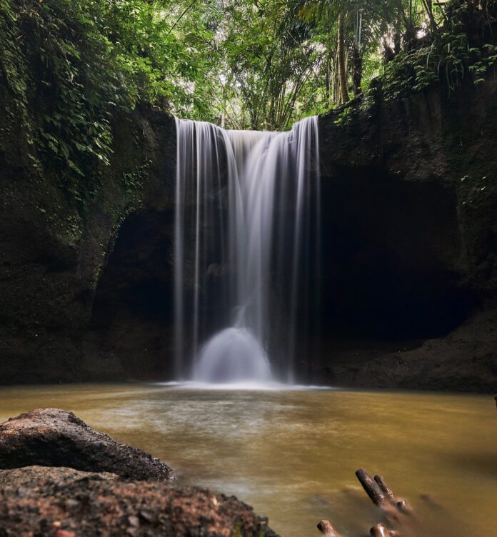 Photo by Norbert Braun a waterfall in a forest