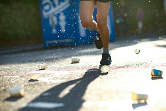 Photo by Norman Meyer person standing on ground with lots of paper cups
