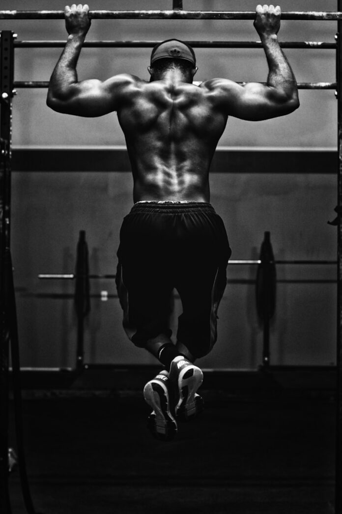 Photo by Edgar Chaparro grayscale photo of man working out