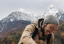 운동으로 건강과 자신감 찾기 man sitting on railings behind snow capped mountain