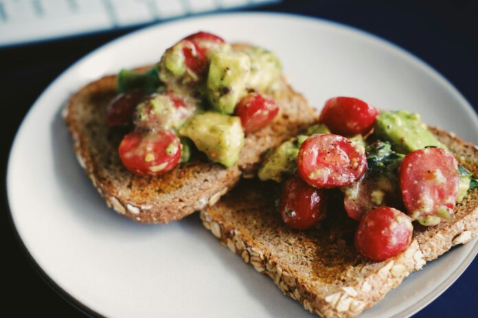 Photo by Ryan Quintal bread with tomato and green vegetable on white ceramic plate