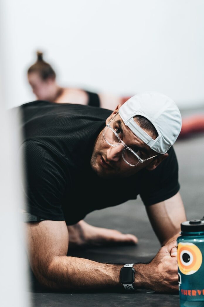 Photo by LOGAN WEAVER | @LGNWVR man in black crew neck t-shirt wearing white cap and black framed eyeglasses
