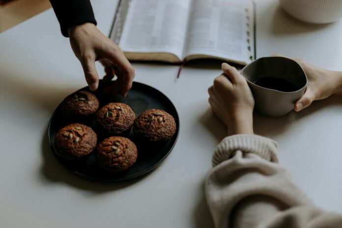 Photo by Priscilla Du Preez 🇨🇦 person holding black ceramic mug with coffee beans