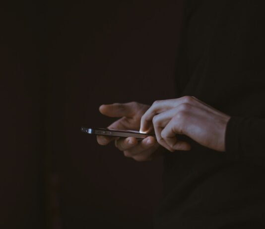 디지털 디톡스와 정신 건강: 스마트폰 중독 탈출의 길 silhouette photo of person holding smartphone