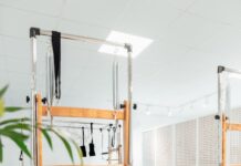 필라테스, 몸과 마음의 균형을 잡아주는 효과적인 운동법 a room filled with lots of machines and a plant