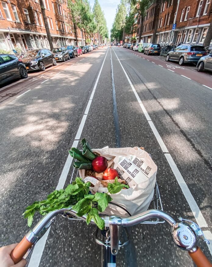 Photo by Boxed Water Is Better red roses in brown cardboard box on bicycle